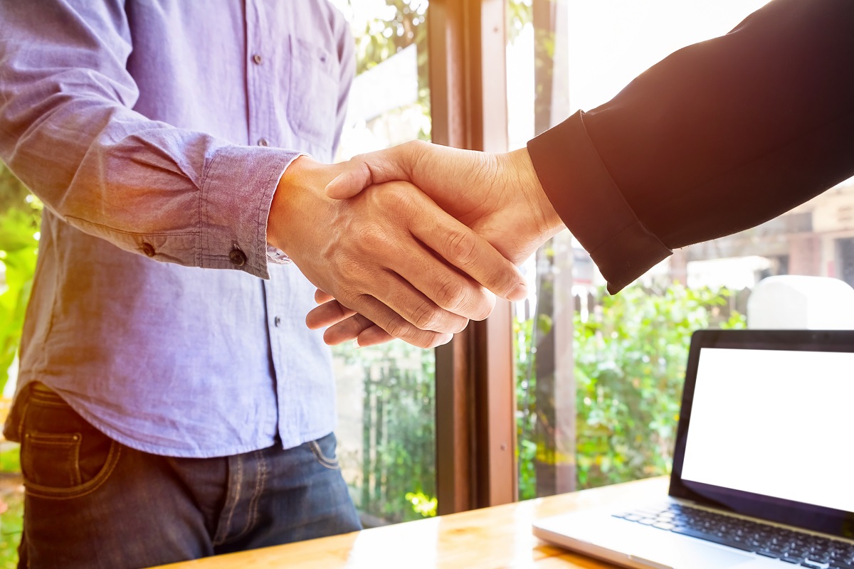 Two business men shaking hands.